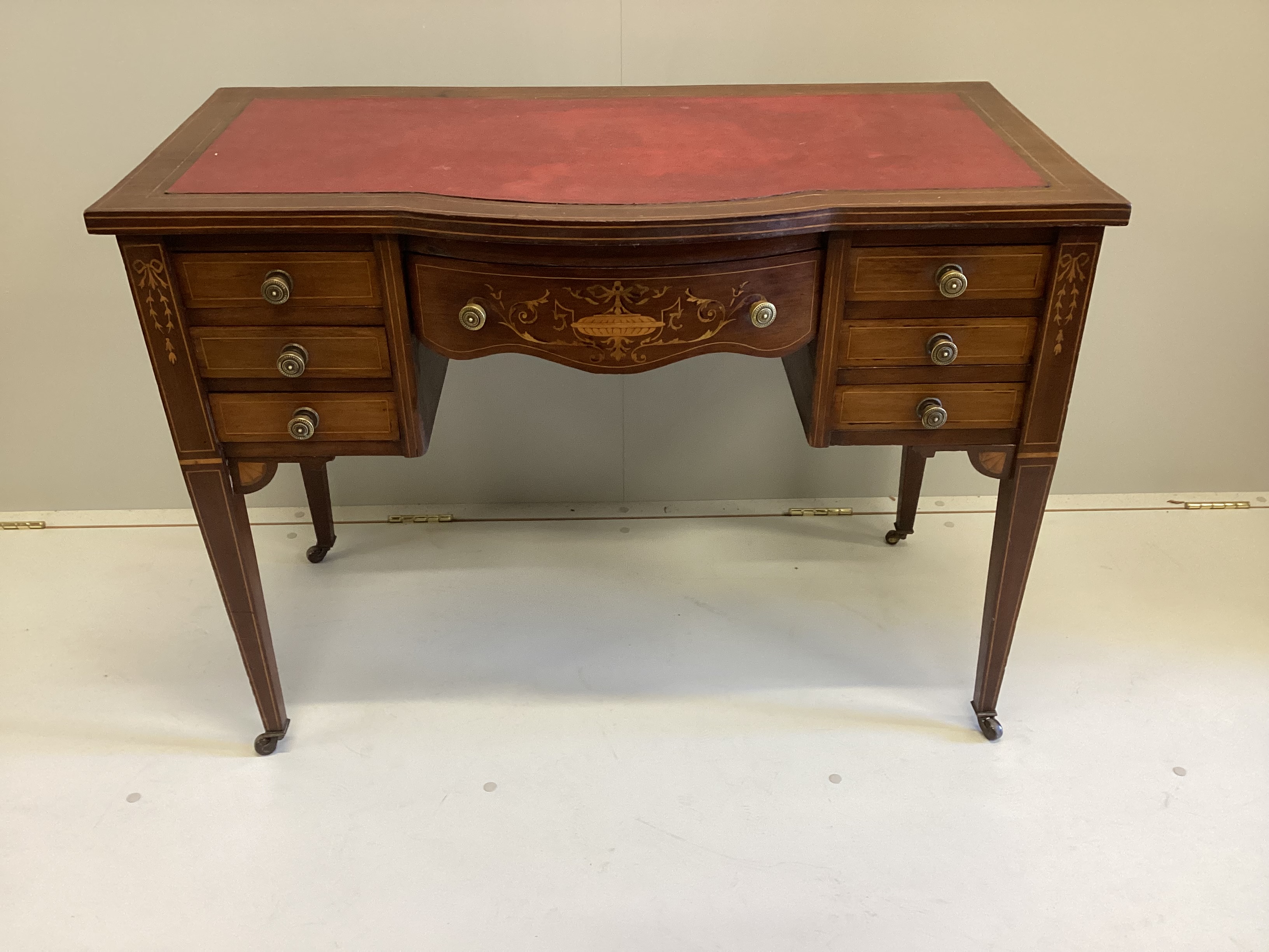 An Edwardian inlaid mahogany bowfront kneehole writing table, width 99cm, depth 52cm, height 73cm